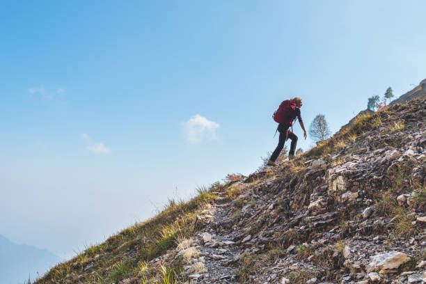Hiker woman during ascend on mountain