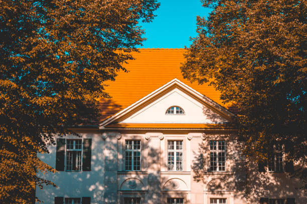 historical building with red roof and autumn trees