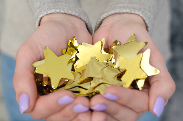 istock Many foil stars in hand. 1056843800