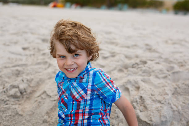 istock little kid boy running on the beach of ocean 1056847882