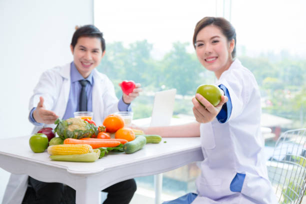 istock Nutritionists with vegetable and fruit for your heart. 1056853836