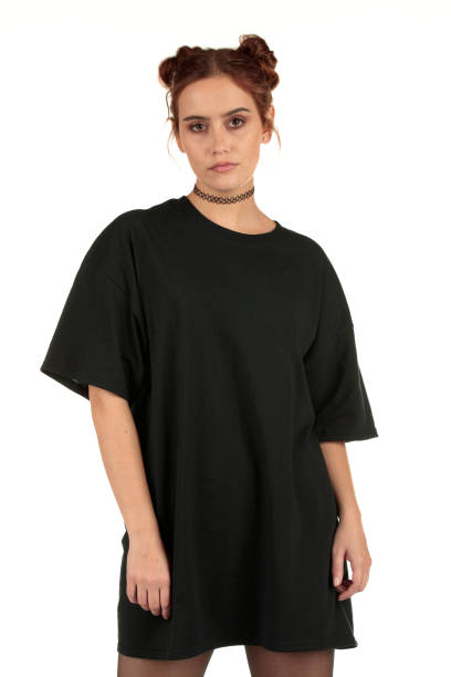 Urban street wear fashion model wearing a blank oversized t-shirt dress perfect for your design Girl with auburn, brunette hair in space buns with a high attitude streetwear fashion look displaying a blank t-shirt ready for your design mock-up too big stock pictures, royalty-free photos & images