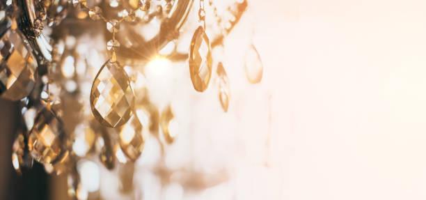 abstract image background of blur bokeh and crystal chandelier light equipment filter tone color effect stock photo