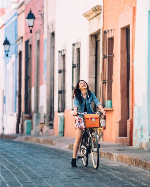 istock Young woman commuting on bicycle 1056861970