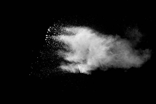 istock Explosion of white dust on black background. 1056862288