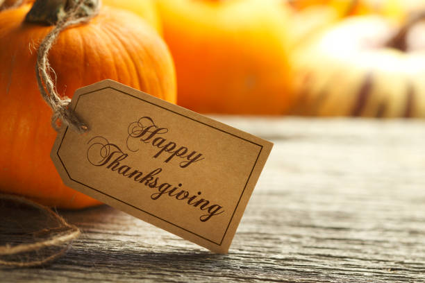 istock Happy Thanksgiving Tag Hanging From A Pumpkin 1056864532