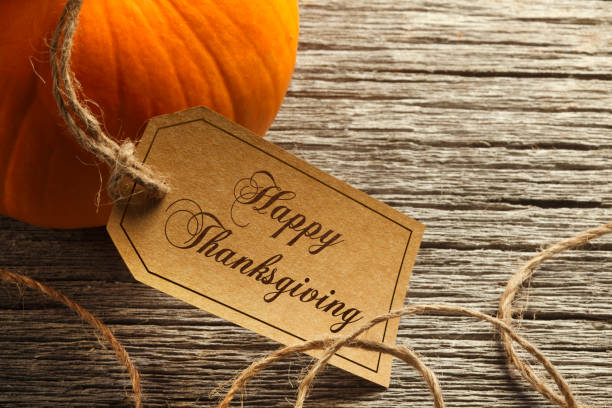 istock Happy Thanksgiving Tag Hangs From A Pumpkin 1056864598