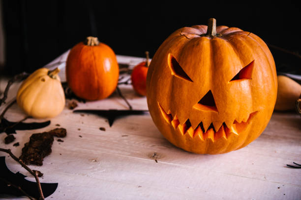istock Halloween decoration with pumpkin and spiders on wooden background 1056864774