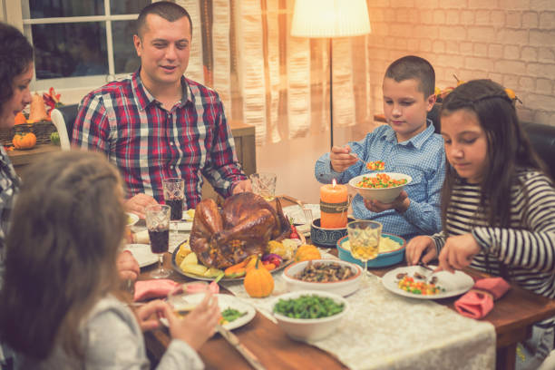 istock Family Celebrating Thanksgiving Day at Home 1056864912