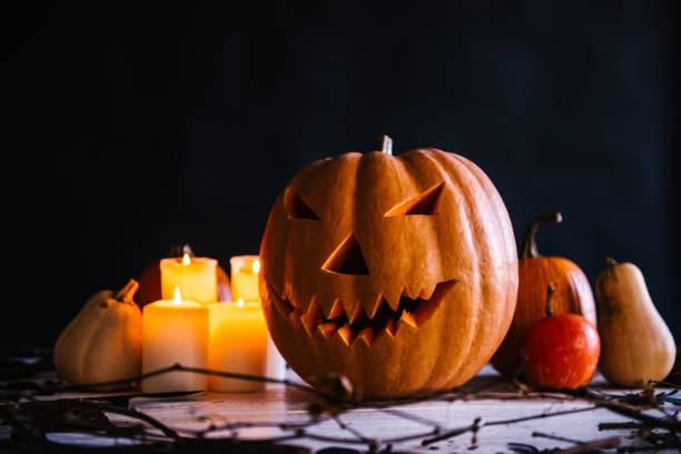 istock Halloween composition of pumpkins and burning candles 1056866704