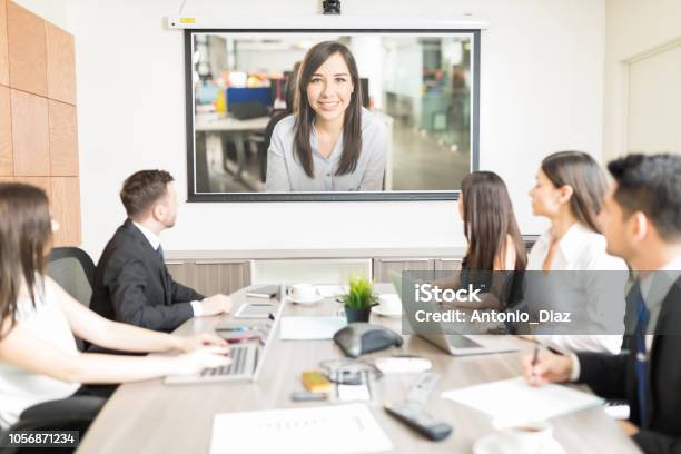 Executives Looking At Blank Projection Screen In Meeting Stock Photo - Download Image Now