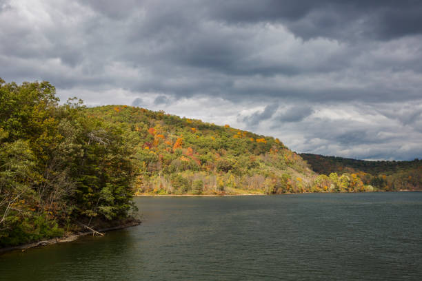istock Dramatic Storm Clouds Above Autumn Hills And Lake 1056871916