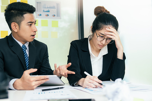 Business teamwork blaming partner and serious discussion. Colleagues argue about investment document  disagree having conflict at work, diverse coworkers disputing about mistake in paperwork.