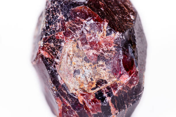 istock Macro of a mineral garnet stone on a white background 1056872618