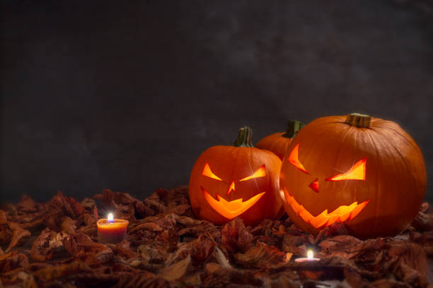 istock Carving halloween pumpkins on wooden plank background. 1056872870