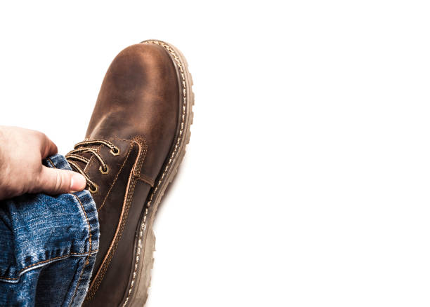 istock Men's brown boots and blue jeans isolated 1056873932