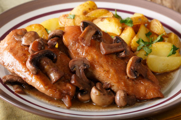 istock Chicken Marsala with garnish of potatoes macro. horizontal 1056874400