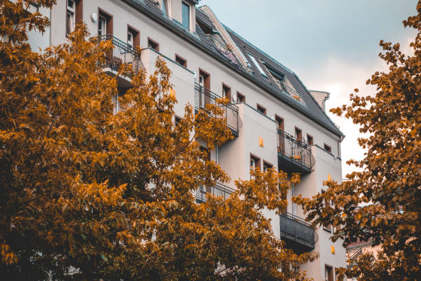 istock white apartment building for real estate themes with orange trees 1056874844