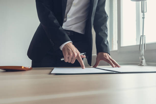 istock Businessman pointing where to sign a contract 1056877970