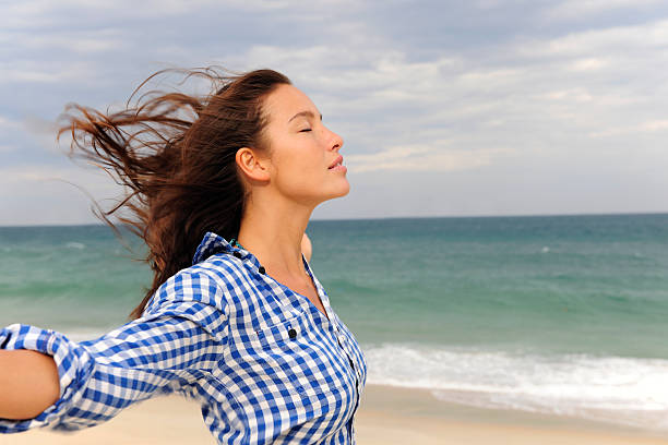 istock woman enjoying the sea and wind 105687923