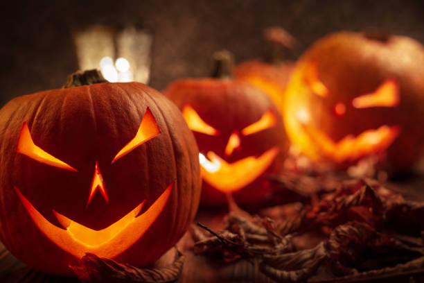 istock Carving halloween pumpkins on wooden plank background. 1056881484