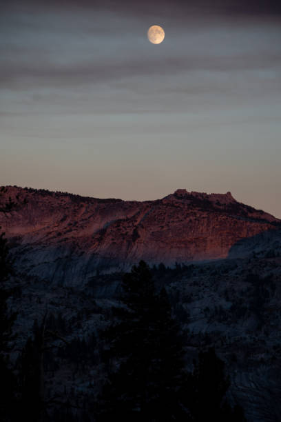 istock The moon over mountains in the wilderness 1056881640