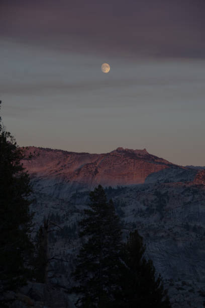 istock The moon over mountains in the wilderness 1056881642