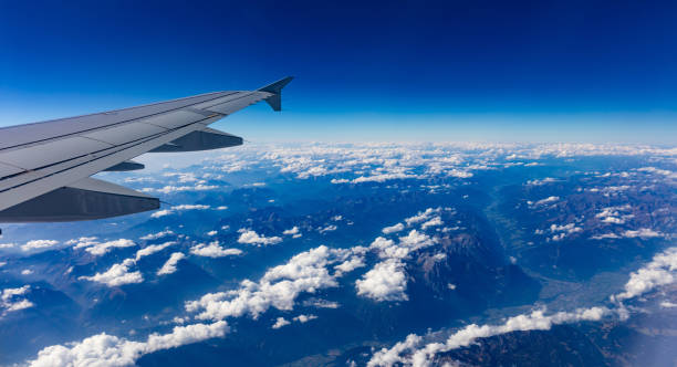 istock Mountains and blue sky. View out of an airplane window. 1056881972