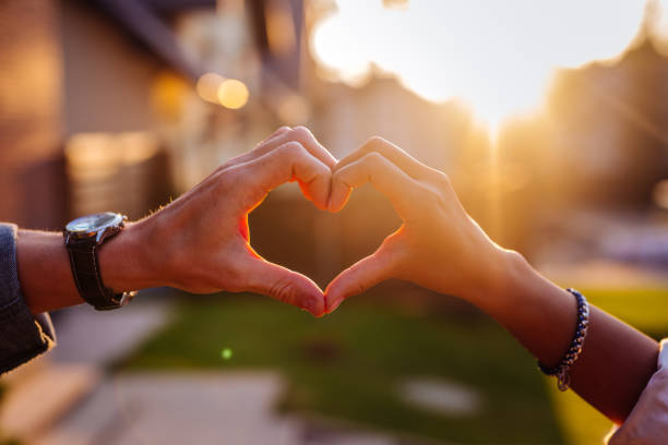 istock Hands of nice young people showing the heart 1056884408