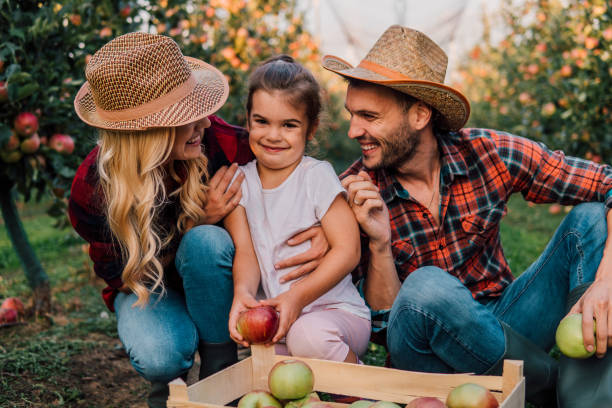 istock Happy farmers with young girl 1056885022