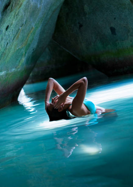 istock Bikini woman in the cave at the Baths, Virgin Gorda 1056885576