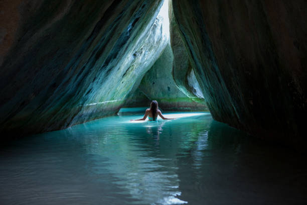 Bikini woman in the cave at the Baths, Virgin Gorda stock photo