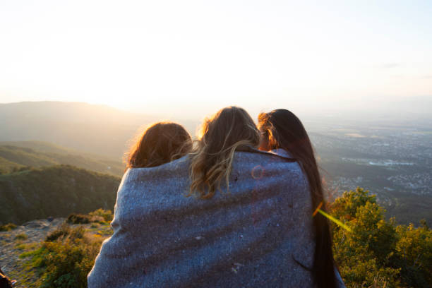 Women on mountain peak cliff