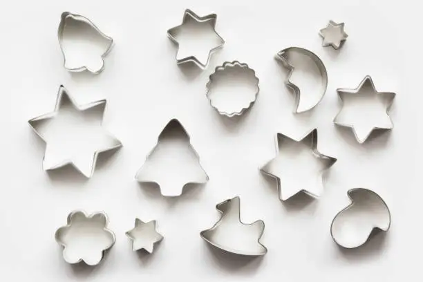 Various Christmas-themed cookie cutters.Christmas cookie cutters on white. Holiday pattern.
