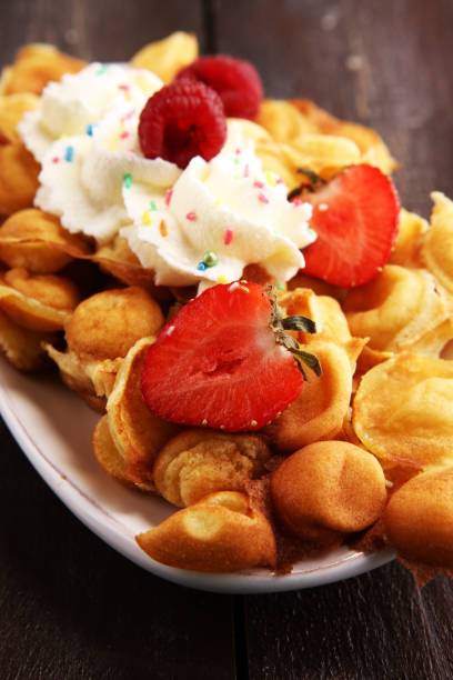 istock Hong Kong style egg waffle on wooden board. bubble waffle 1056886324