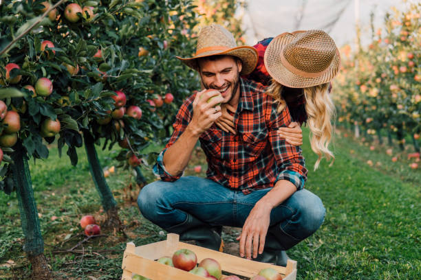 istock Woman hugging young farmer 1056886326
