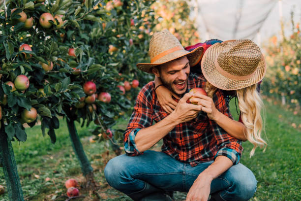 istock Couple holding an apple and smiling 1056886356