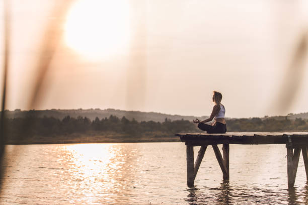 istock Young woman doing yoga meditation 1056886376