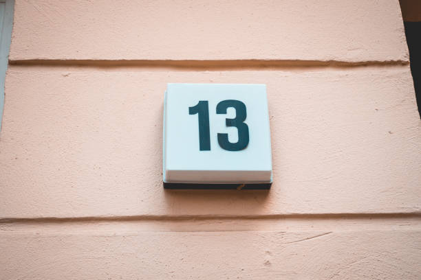 istock number 13 door sign on orange background 1056890476