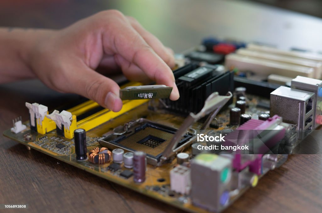 Microprocessor Socket. Shop Technician Plug In Cpu Microprocessor To Motherboard Socket Workshop ...