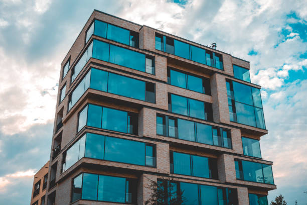istock big apartment building in futuristic cube style with panoramic windows and dramatic sky in the background 1056896182