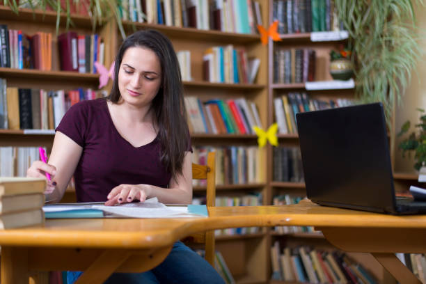istock Student girl in the library. 1056898002