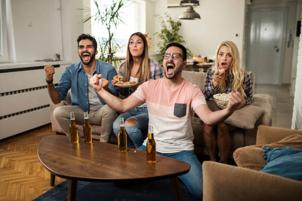 istock Friends watching sport on tv. 1056898038