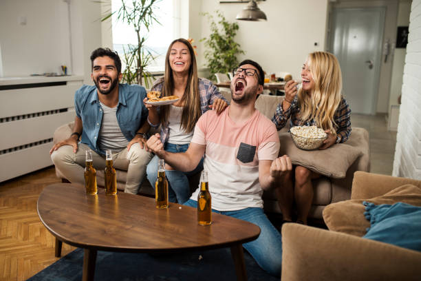 istock Friends watching sport on tv. 1056898042