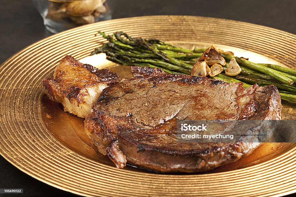 Steak Steak with asparagus and garlic slices Asparagus Stock Photo