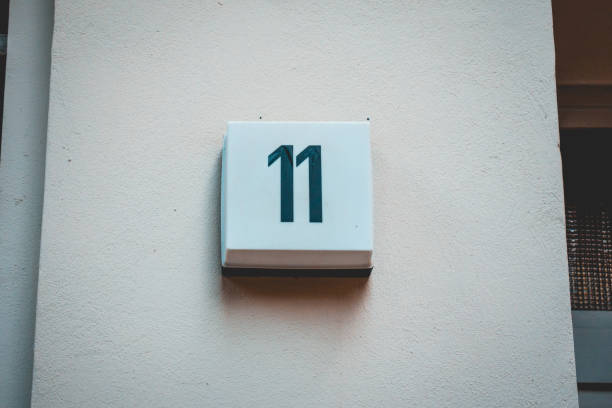 istock white facade with number 11 door sign 1056903460