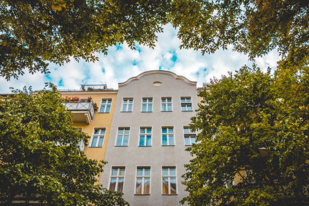 istock residential grey building framey by green branches 1056903614