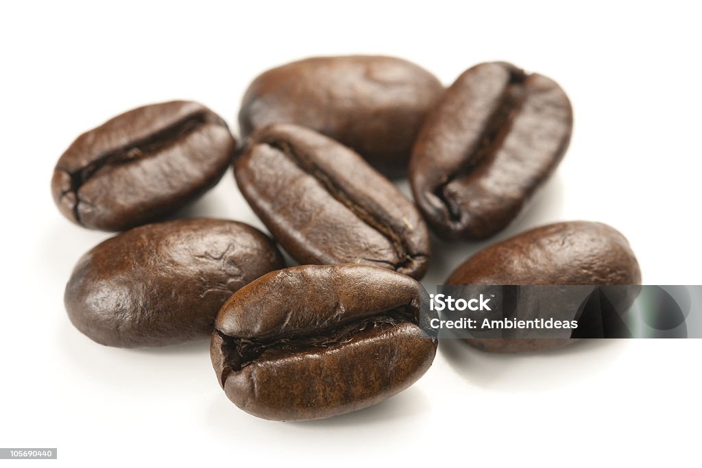 Brown coffee beans on a white background Coffee beans close up macro isolated on white bacground and studio shot. Brown Stock Photo