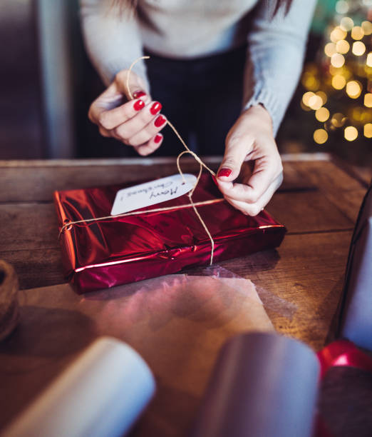 istock woman making the package for the christmas gift 1056905474