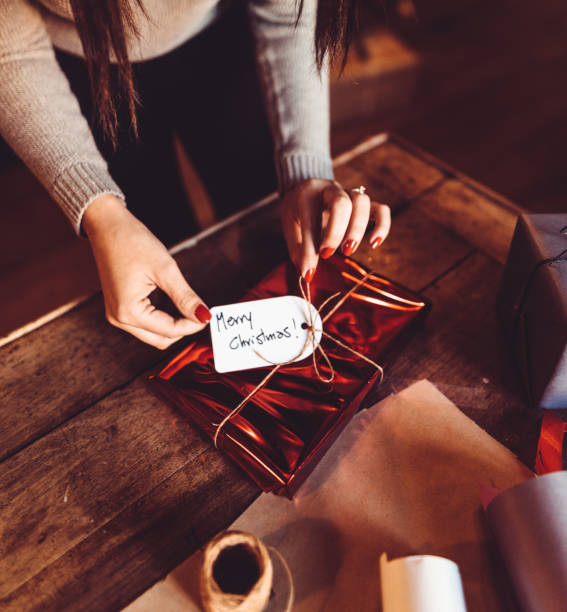 istock woman making the package for the christmas gift 1056905838